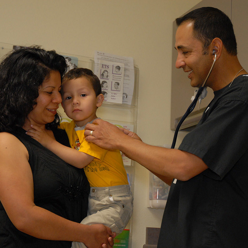 Male doctor, mom, and small child