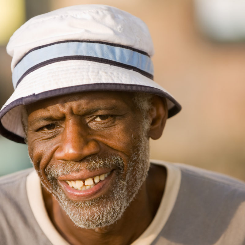 Senior man smiles at camera