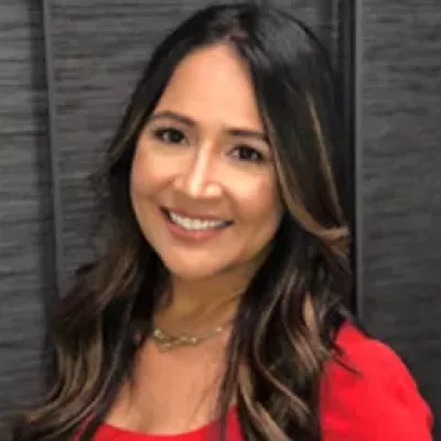 Woman in red top smiles at camera